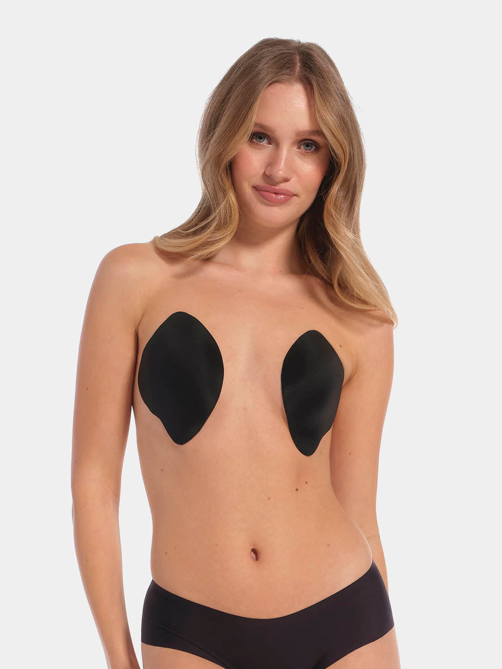 Front view of a model wearing the Ultimate Invisibles adhesive bra cups, showcasing the lightweight, backless and strapless design with two separate smooth cups that create natural-looking cleavage and an invisible finish under clothing.