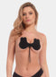 Front view of a model wearing the Va-Va-Voom Lift adhesive bra, standing naturally to showcase the strapless, backless design that lifts and shapes the breasts while providing smooth coverage and a seamless, invisible look under clothing.