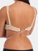 Back view of a model wearing a bra with the white Low Back Strap attached, showing the clear silicone strap crossing low along the back to create a low-back effect while remaining discreet and nearly invisible under clothing.