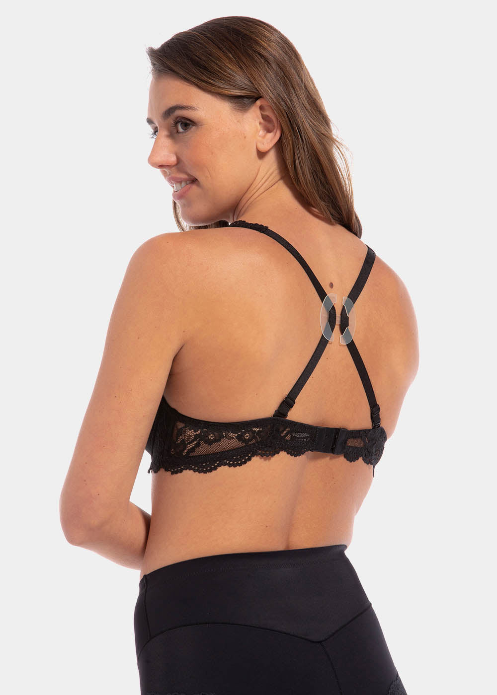 Back view of a model demonstrating the Magic Clip, showing how the soft plastic clip pulls the bra straps together to create a racerback effect and prevent straps from sliding, with a secure and discreet fit.