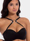 Front view of a model demonstrating the Magic Clip, showing how the soft plastic clip pulls bra straps together to create a racerback effect and prevent straps from sliding. The image highlights the discreet fit and adjustable positioning at the front of the bra.