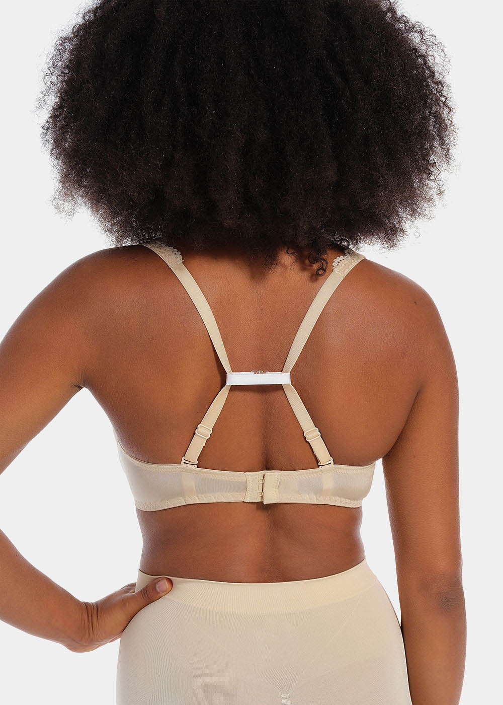 Back view of a model demonstrating different ways to use the Magic Straps, showing how the soft fabric clips pull bra straps together to create a racerback effect and prevent slipping. The image highlights multiple styling options and the discreet fit under clothing.