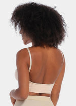 Back view of a model wearing the latte-colored Bamboo Low Back Bra, showcasing the low-back styling with a smooth, seamless finish and adjustable spaghetti straps for a perfect fit under open-back tops and dresses.