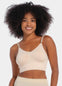 Front view of a model wearing the latte-colored Bamboo Low Back Bra, featuring a seamless, wireless design made from soft bamboo fabric. The bra includes built-in support, removable inlay pads for shaping, and adjustable spaghetti straps for a customized fit.