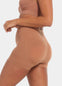 Person wearing a brown sports bra and Booty Booster Short on a light gray background