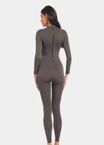 Back view of a model wearing the chocolate-colored Bodycon Jumpsuit, showcasing the long back zipper for easy wear, the seamless finish, and the smooth, curve-hugging full-length silhouette.