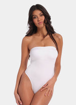 Front view of a model wearing the white Bandeau Thong Body, featuring a seamless, wireless bandeau design with built-in bust support, medium shaping through the waist and tummy, and a smooth, strapless silhouette.
