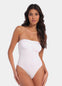 Front view of a model wearing the white Bandeau Thong Body, featuring a seamless, wireless bandeau design with built-in bust support, medium shaping through the waist and tummy, and a smooth, strapless silhouette.