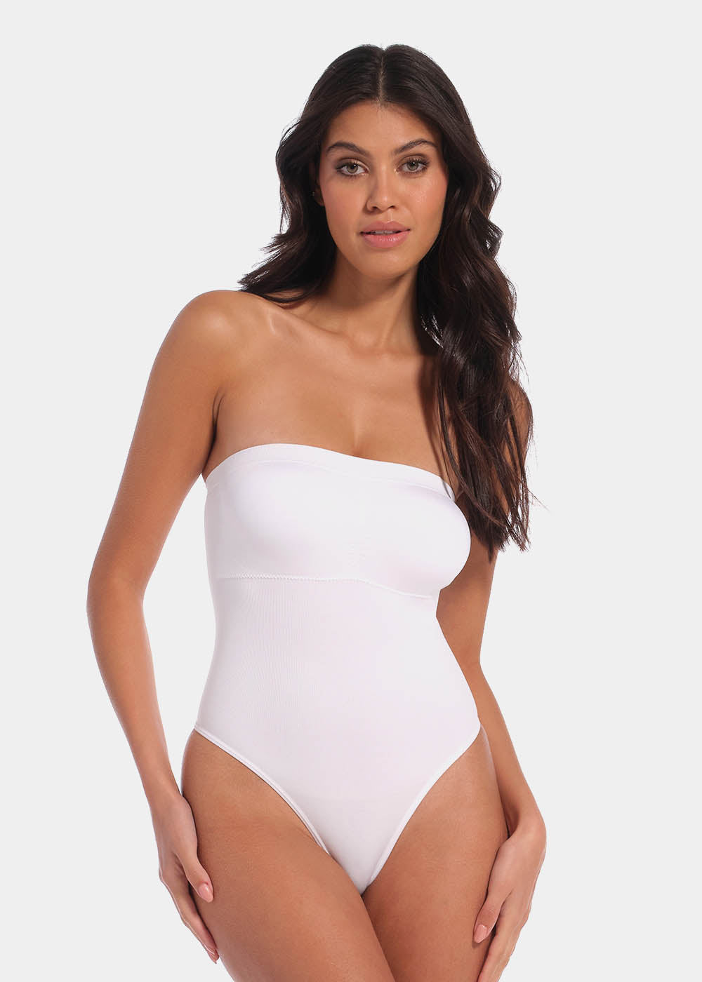 Front view of a model wearing the white Bandeau Thong Body, featuring a seamless, wireless bandeau design with built-in bust support, medium shaping through the waist and tummy, and a smooth, strapless silhouette.