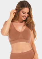 Woman wearing a brown Bamboo Comfort Bra and leggings on a white background