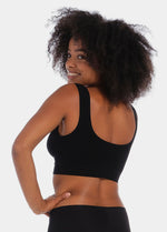 Woman wearing a black Bamboo Comfort Bra against a white background