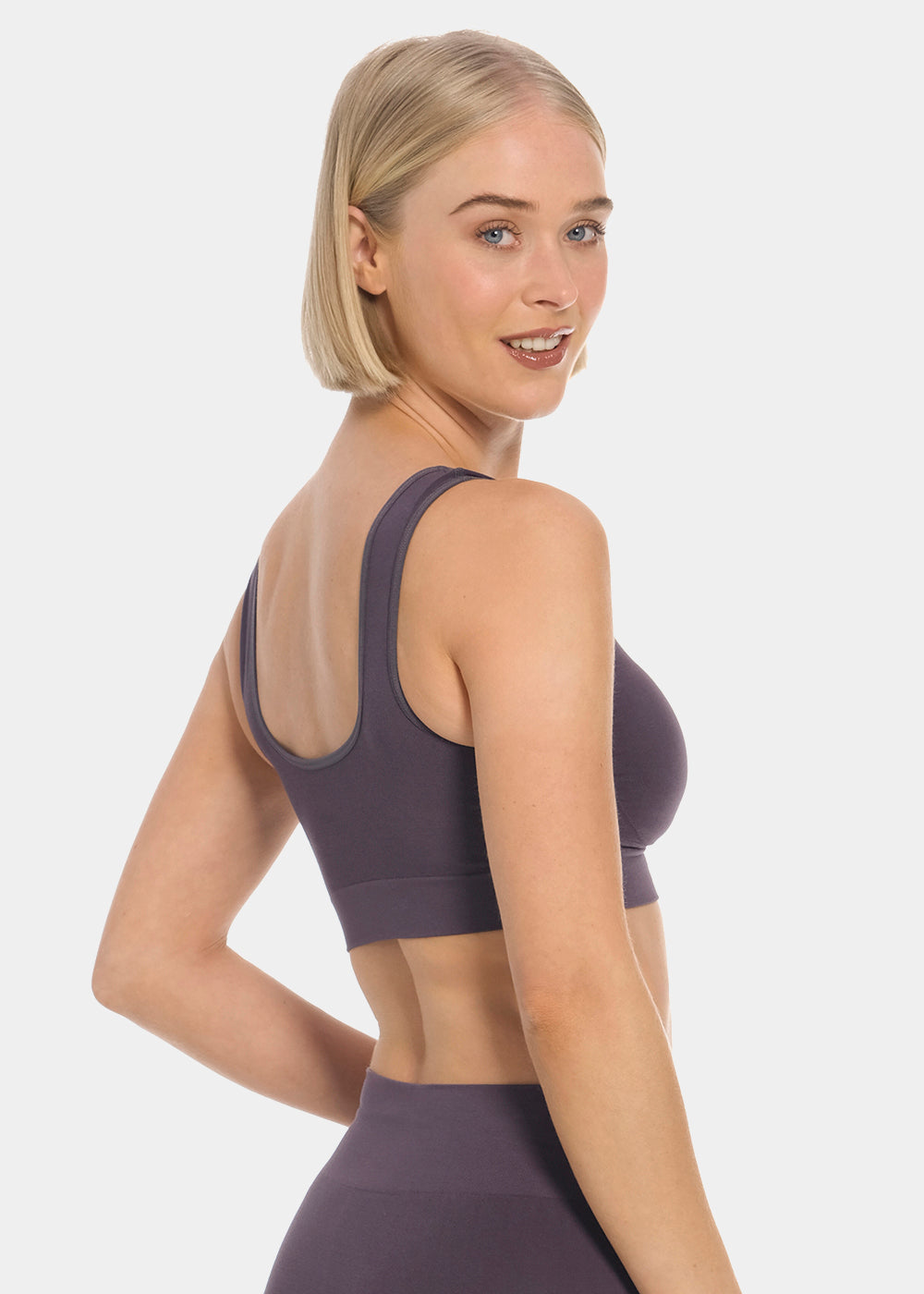 Woman wearing a dark purple Bamboo Comfort Bra and leggings on a light gray background