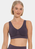 Woman wearing a dark purple Bamboo Comfort Bra and leggings on a white background