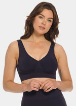 Woman wearing a navy blue Bamboo Comfort Bra and leggings on a white background