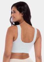 Woman wearing a light blue Bamboo Comfort Bra on a white background
