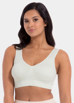 Woman wearing a light green Bamboo Comfort Bra against a white background