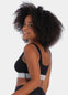 Front view of a model wearing the Salsa Bra, featuring a soft, seamless wireless design with wide supportive straps and removable pads. The bra has built-in support and a silver sparkling band under the bust that adds a subtle, stylish shimmer.