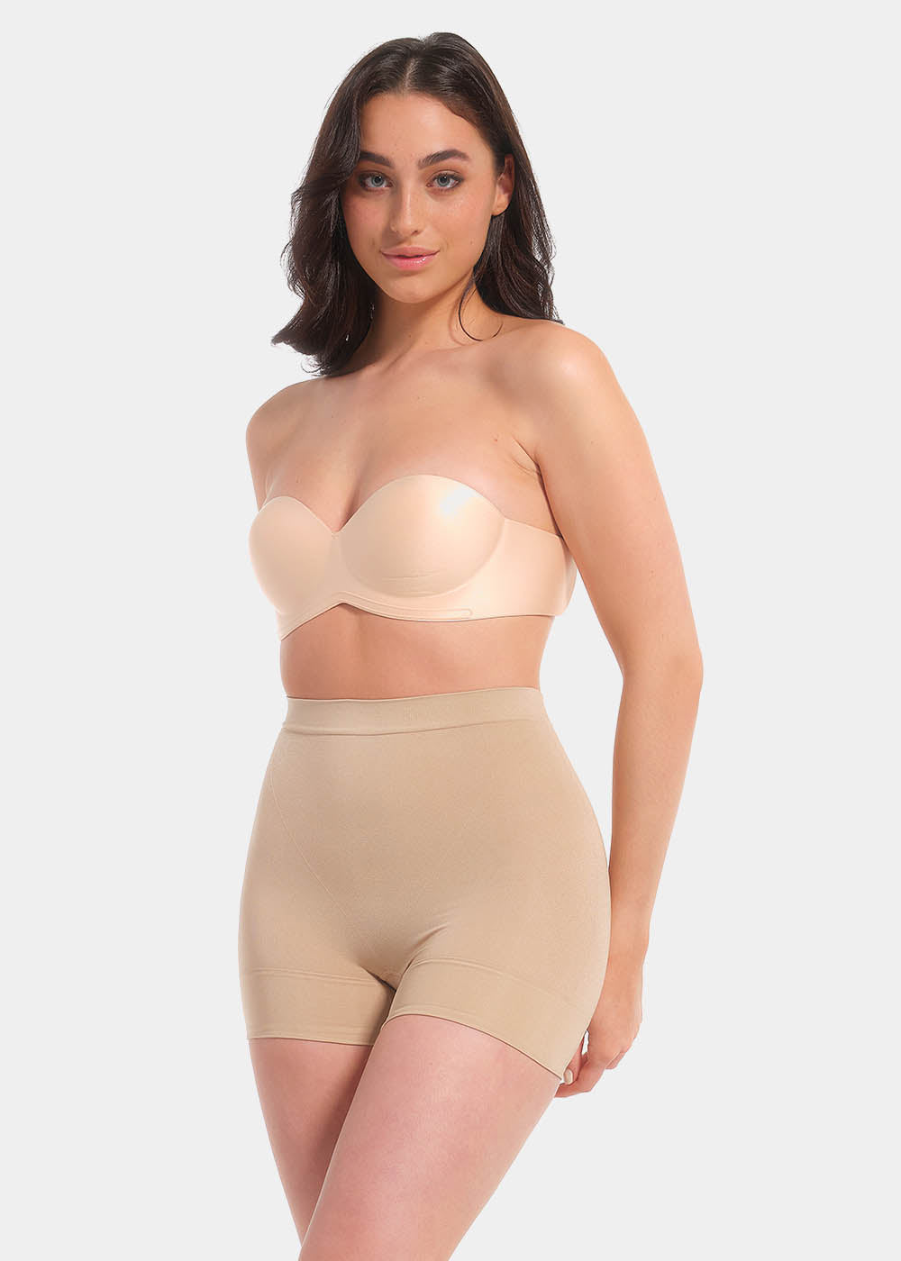 A woman wearing a cappuccino wing bra with adhesive backless design, showing the side with the additional support wing.
