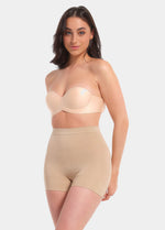 A person wearing a black comfort short that reaches mid-thigh, made of a smooth, solid fabric.