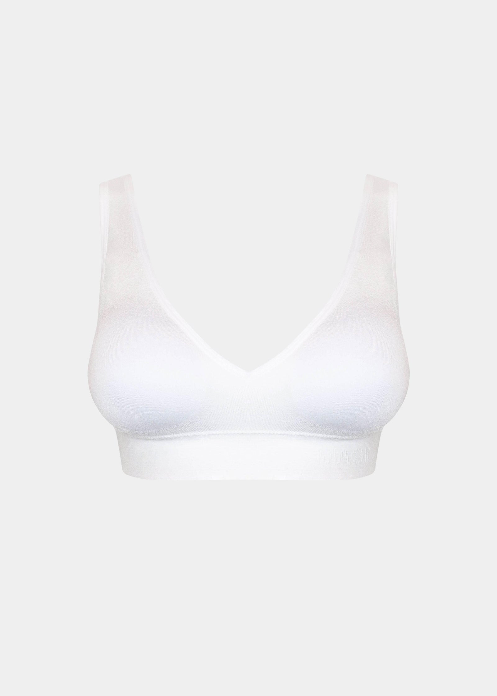 Front product view of the white Comfort Plunge Bra, highlighting the deep V-neckline, soft seamless fabric, wireless design, and smooth, clean finish with wide supportive straps.