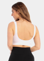 Back view of a model wearing the white Comfort Plunge Bra, showcasing the smooth, seamless back with no closure, wide comfortable straps, and a clean, irritation-free finish.