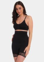 A model wearing high-waisted black shorts with lace details on the legs.