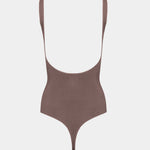 Brown body with thin straps on a light gray background