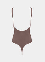 Brown body with thin straps on a light gray background