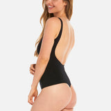 Woman wearing a black swimsuit with a cutout design on a white background