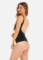 Woman wearing a black swimsuit with a cutout design on a white background