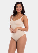 Woman wearing a beige bodysuit on a white background
