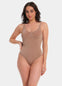 Woman wearing a light brown bodysuit against a white background