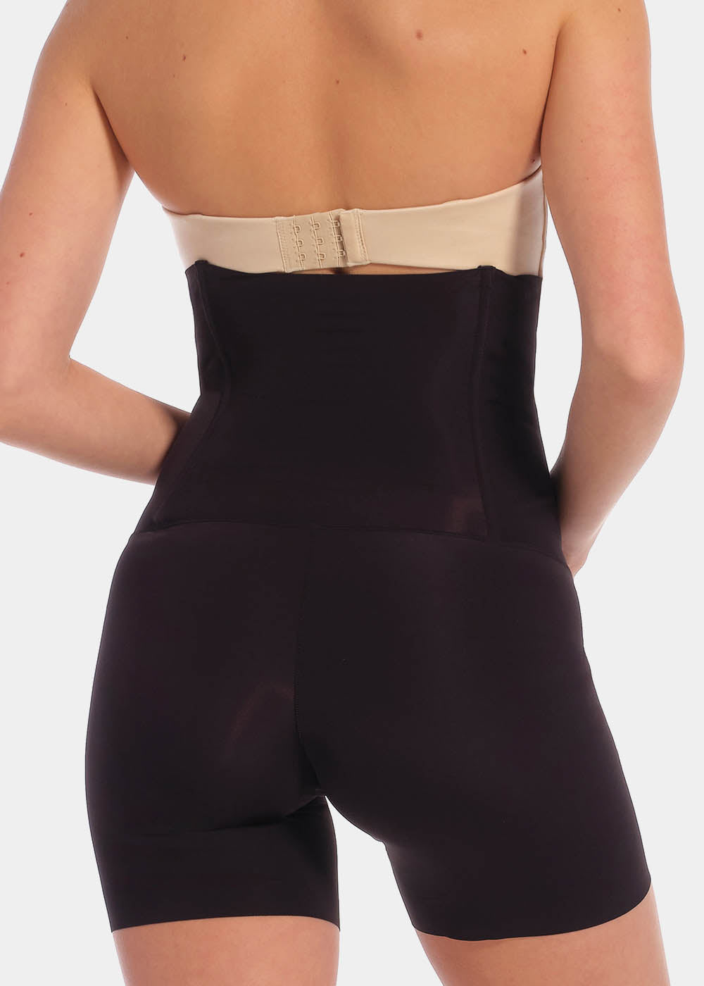 A model wearing high-waisted black Body Control Bermuda, back view