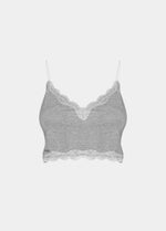 this picture shows a white cozy crop top with V-neckline and lace detail, with ultra thin spaghetti straps. (still front view)