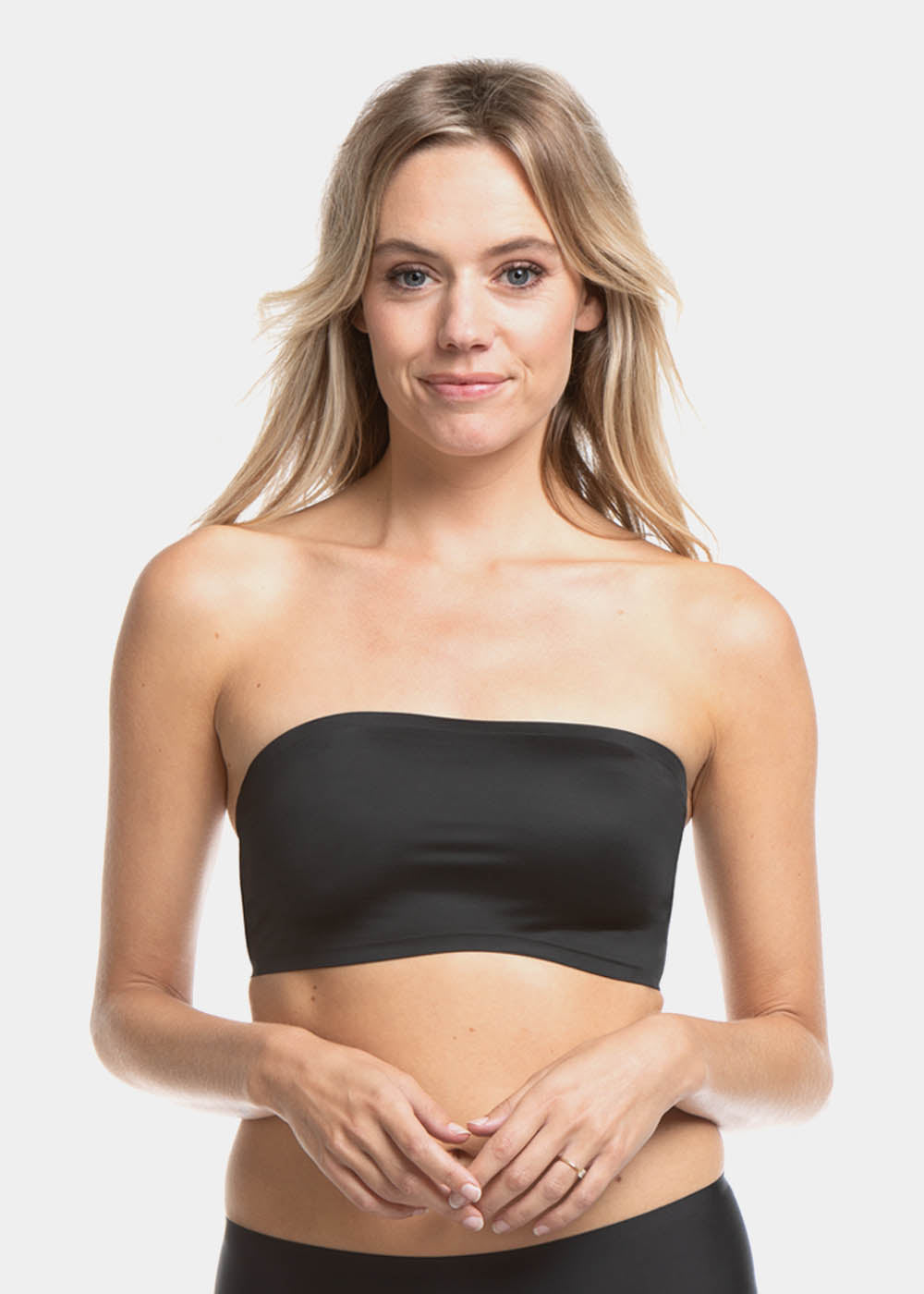 A woman wearing a black bandeau bra with a luxury satin look.