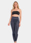 A woman wearing a black/doppio Gloss Legging  with a high waist, standing against a white background.
