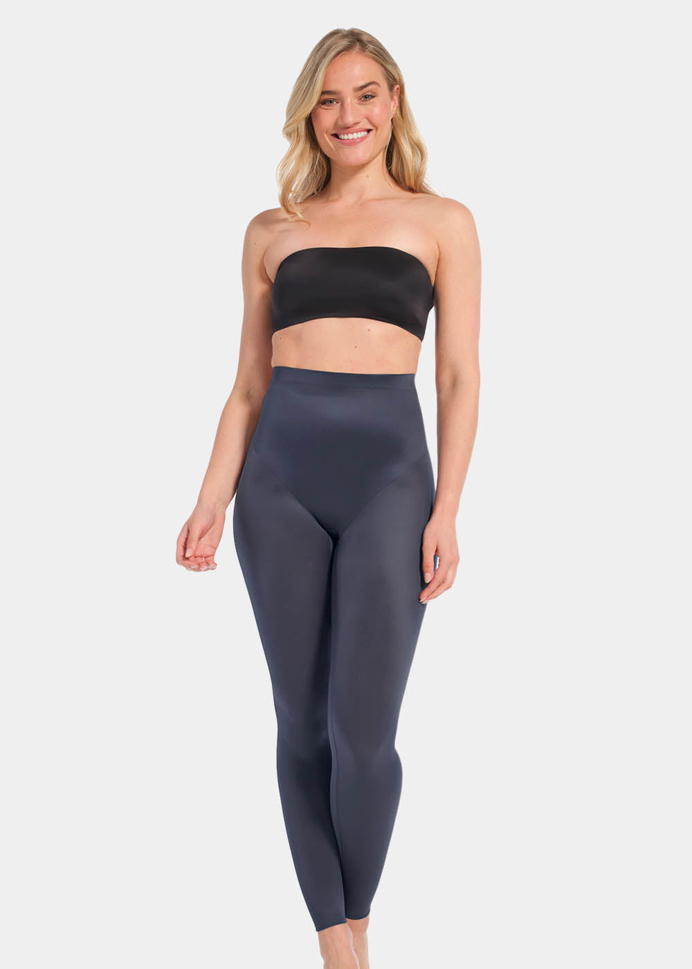 A woman wearing a black/doppio Gloss Legging  with a high waist, standing against a white background.