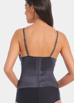 A model wearing the Gloss Low Plunge Top. Showing it from the back to show the straps and hook and closure back
