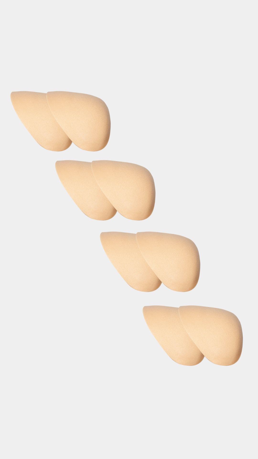 Set of four beige silicone shoulderpads on a white background