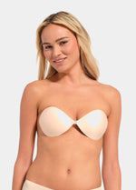 Woman wearing a strapless latte Backless Beauty bra on a plain background