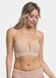 Woman wearing a caramel strapless LUve Bra and underwear on a greyish background