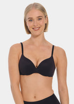 Woman wearing a black MAGIC Push-Up Bra against a plain background