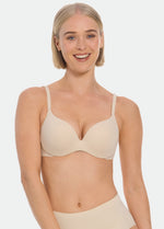 Woman wearing a beige MAGIC Push-Up Bra and underwear on a white background