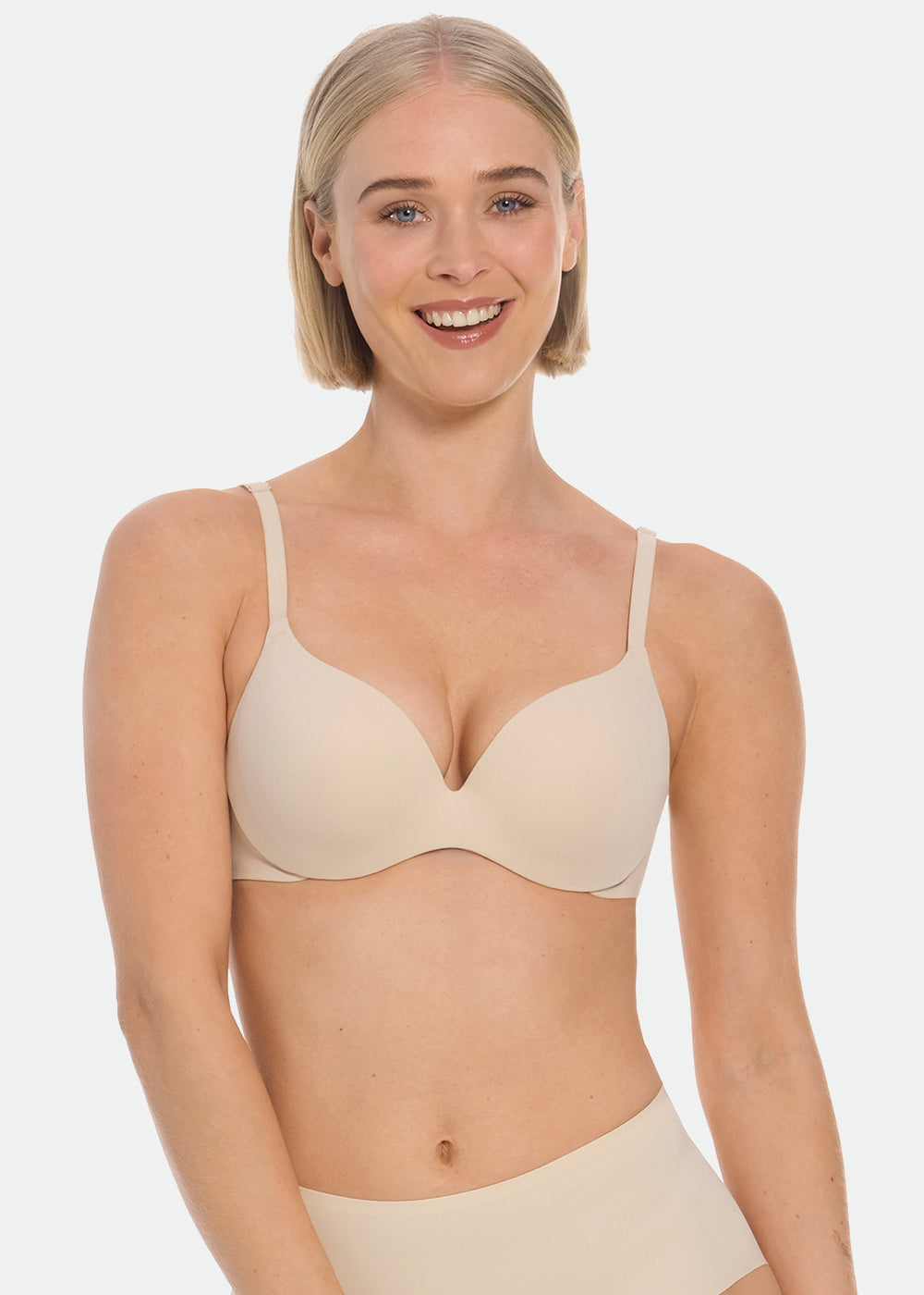 Woman wearing a beige MAGIC Push-Up Bra and underwear on a white background