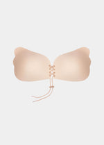 a Latte, backless, strapless adhesive bra with a drawstring front closure.