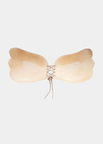 Inside of the Latte, backless, strapless adhesive bra with a drawstring front closure.