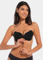 A woman wearing a black, backless, strapless adhesive bra with a drawstring front closure.