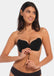 A woman wearing a black, backless, strapless adhesive bra with a drawstring front closure.