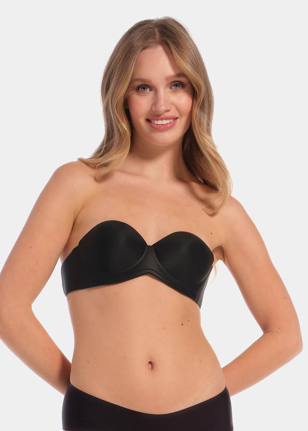 A woman wearing a black wing bra with adhesive backless design, showing the front with the additional support wing.