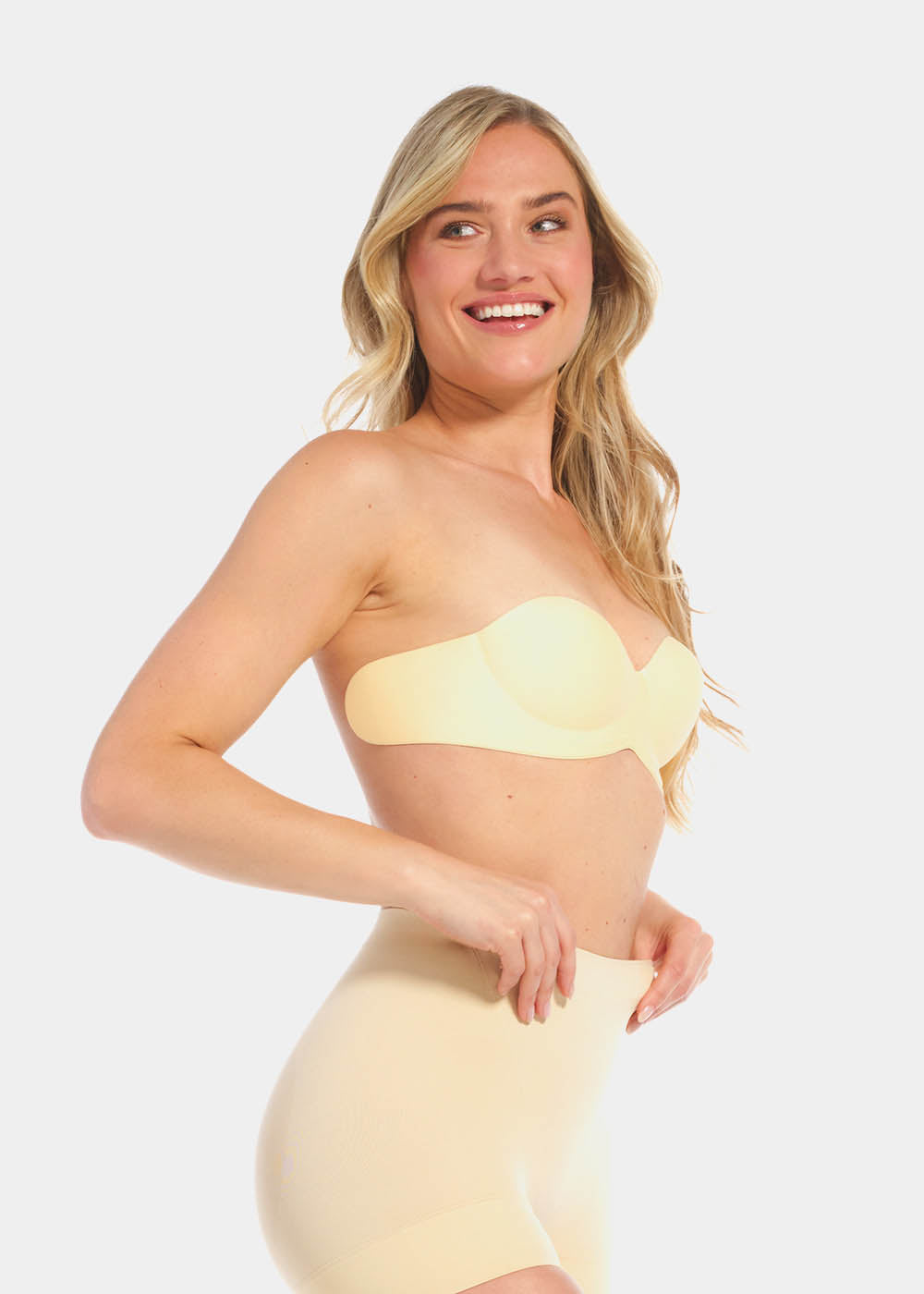 A woman wearing a latte wing bra with adhesive backless design, showing the side with the additional support wing.